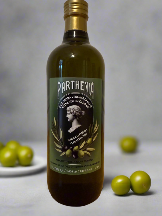Bottle of Parthenia olive oil on a wooden surface with a white wall background