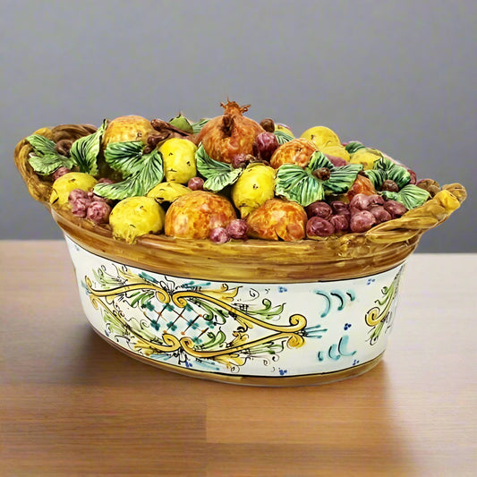 Decorative ceramic bowl with fruit design on a white background