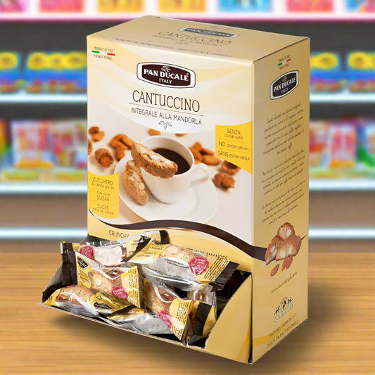 Box of Pan Ducale Cantuccino cookies with a cup of coffee and cookies on a white plate.