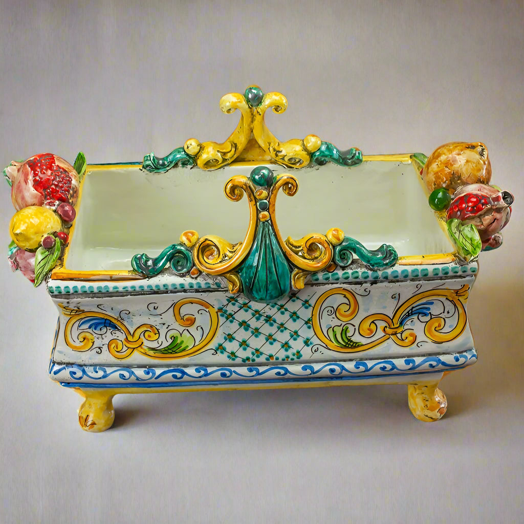 Decorative ceramic piece with colorful floral designs on a dark surface