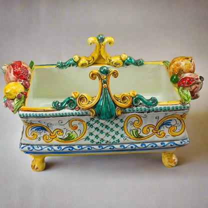 Decorative ceramic piece with colorful floral designs on a dark surface